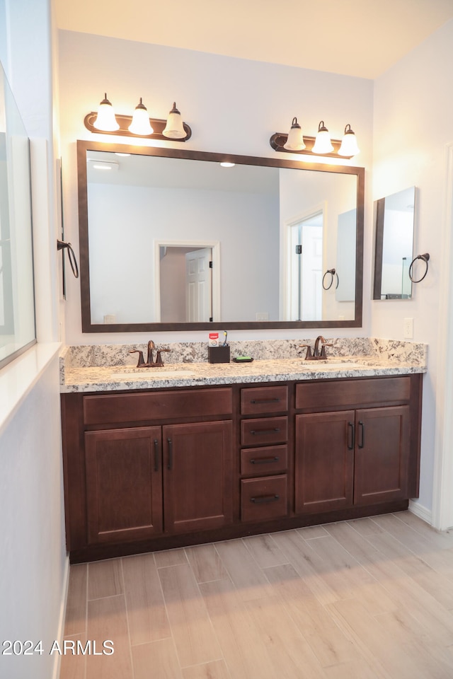 bathroom with hardwood / wood-style floors and vanity