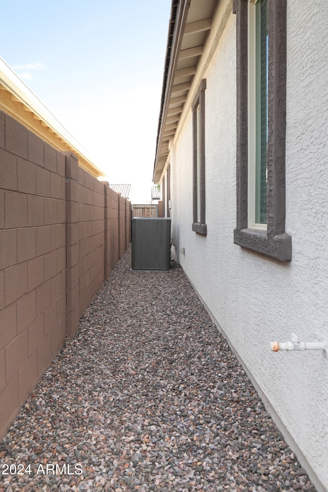 view of side of home with central air condition unit