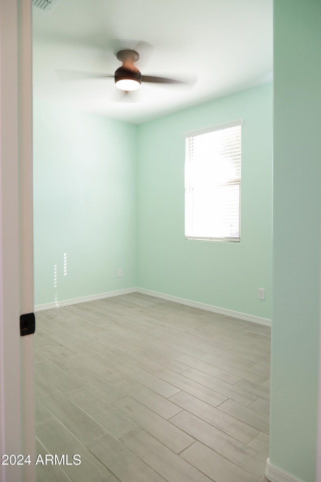 unfurnished room with light wood-type flooring