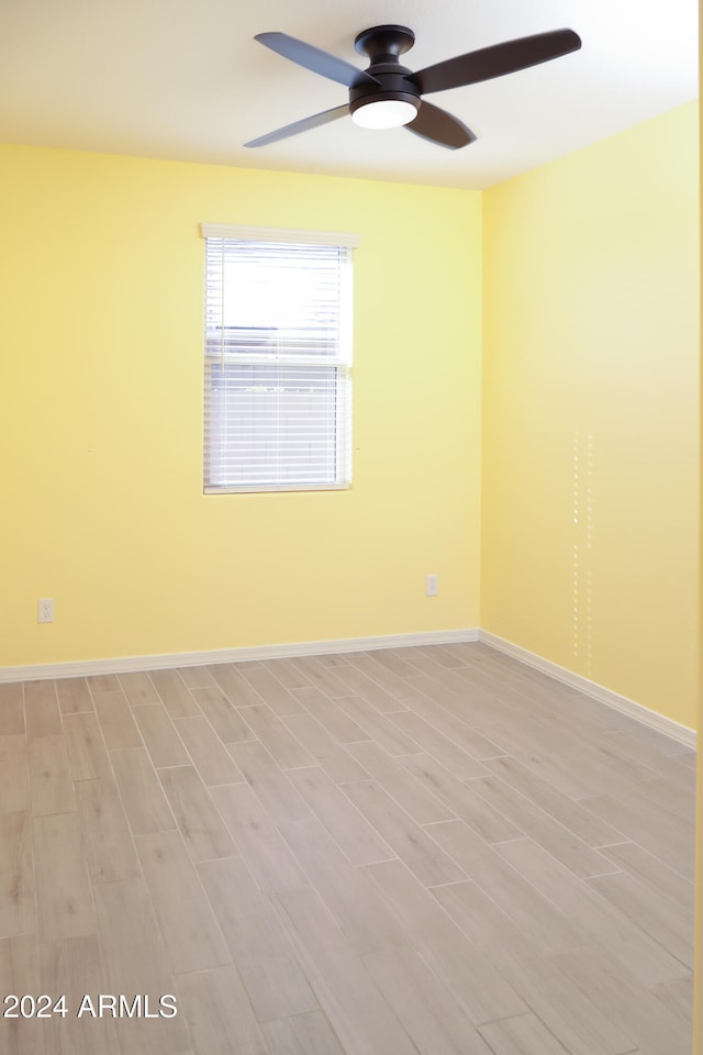 unfurnished room featuring ceiling fan and light hardwood / wood-style floors