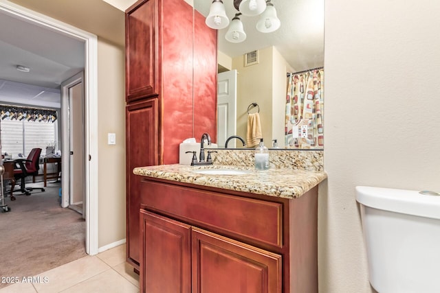 bathroom featuring vanity, tile patterned floors, and toilet