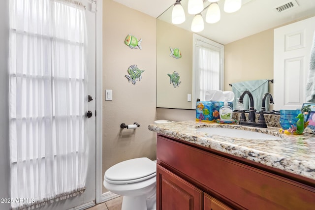 bathroom with vanity, tile patterned floors, and toilet