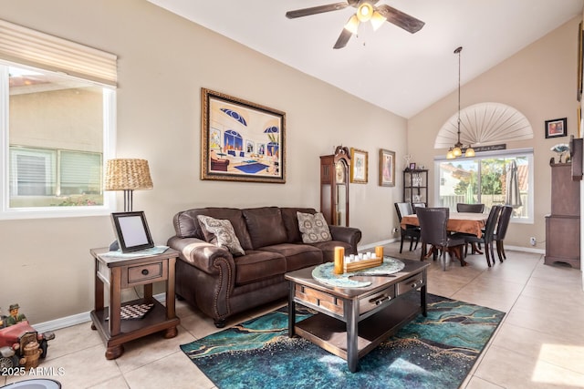 living room featuring ceiling fan, tile patterned floors, and vaulted ceiling