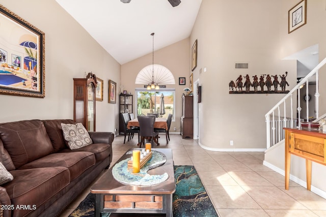 living room with high vaulted ceiling and tile patterned floors