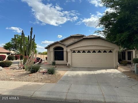 4721 E Abraham Ln, Phoenix, AZ 85050 - view of front of house featuring driveway, an attached garage, and stucco siding