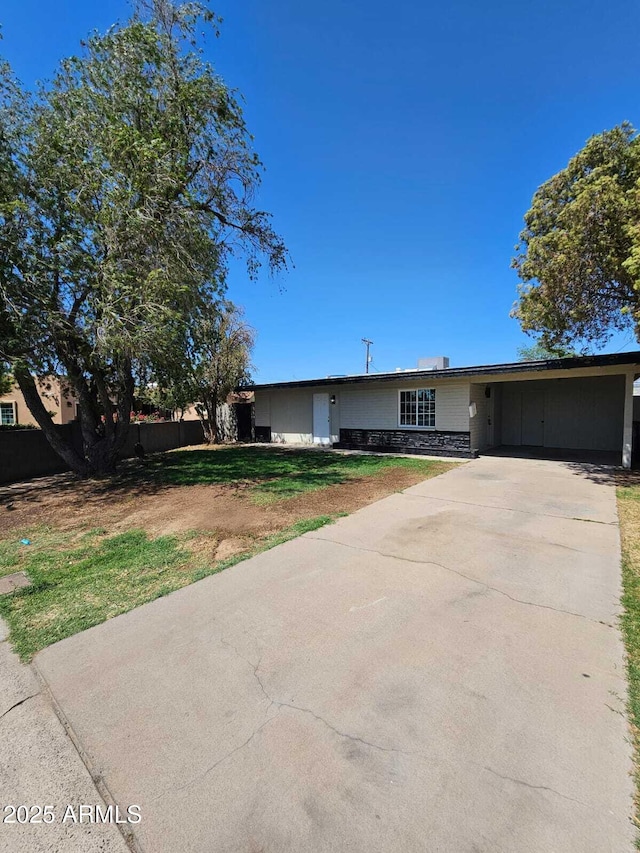 4520 N 28th Dr, Phoenix, AZ 85017 - ranch-style house with concrete driveway, an attached carport, and a front lawn
