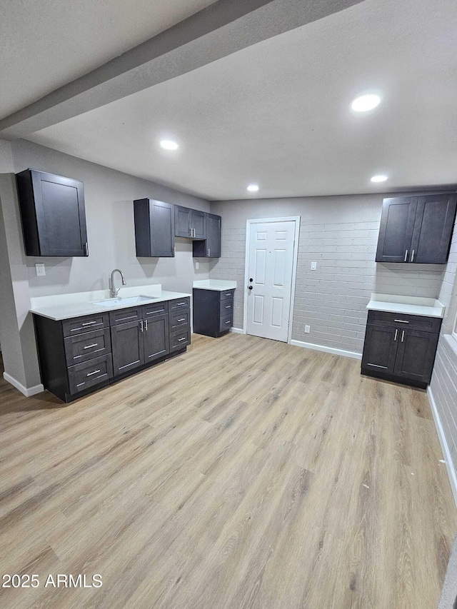 4520 N 28th Dr, Phoenix, AZ 85017 - kitchen featuring light wood-style floors, a sink, baseboards, recessed lighting, and light countertops