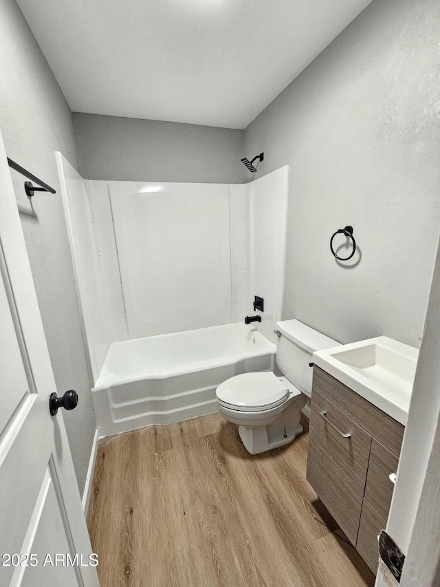 4520 N 28th Dr, Phoenix, AZ 85017 - full bathroom with wood finished floors, toilet, washtub / shower combination, and vanity