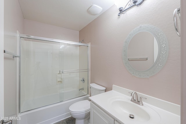 full bathroom with enclosed tub / shower combo, toilet, and vanity