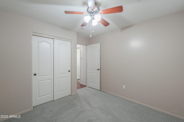 unfurnished bedroom with light colored carpet, a closet, and ceiling fan