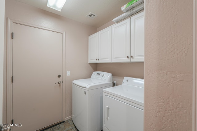 clothes washing area with independent washer and dryer and cabinets