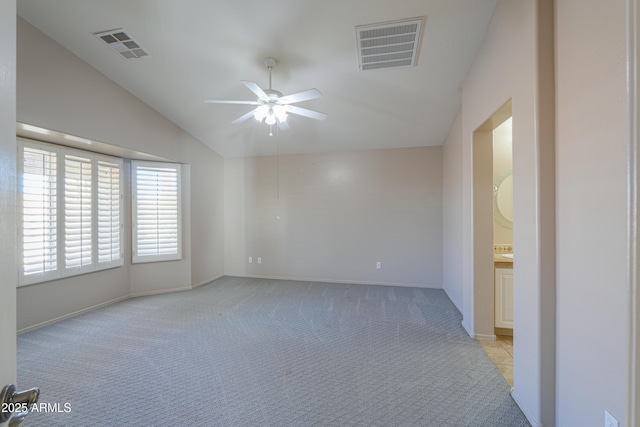 unfurnished room with light carpet, vaulted ceiling, and ceiling fan