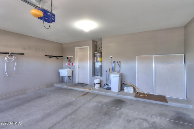 garage featuring a garage door opener, sink, and water heater