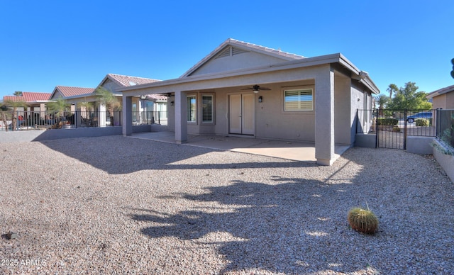 back of property with a patio and ceiling fan