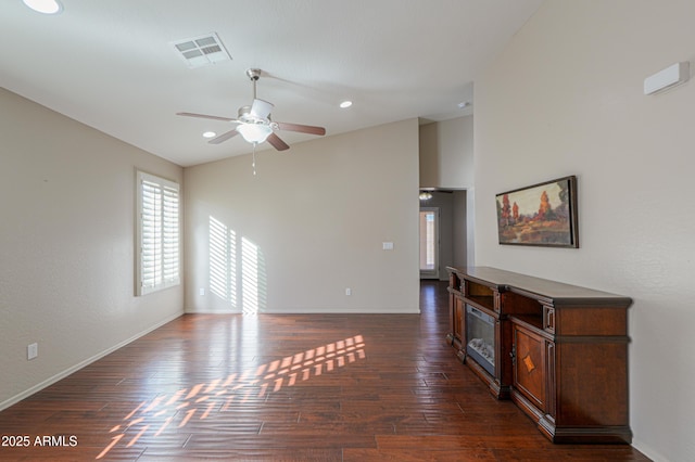 living room featuring ceiling fan, dark hardwood / wood-style floors, and lofted ceiling