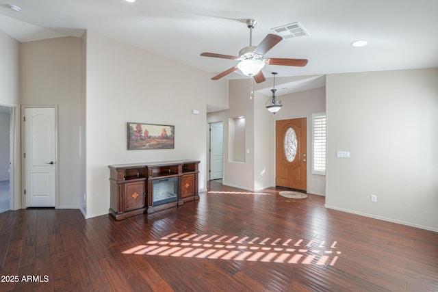 foyer featuring vaulted ceiling, ceiling fan, and dark wood-type flooring