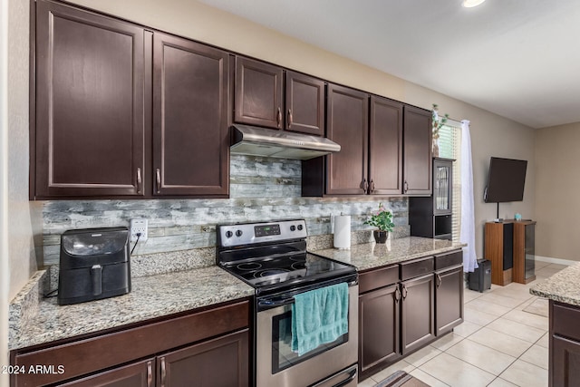 kitchen featuring dark brown cabinets, backsplash, stainless steel electric range oven, and light tile patterned flooring