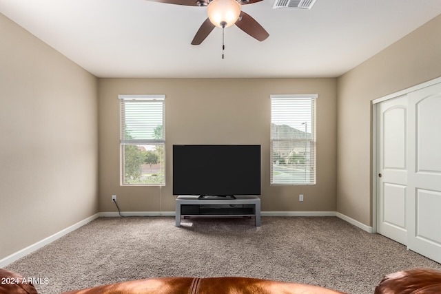 unfurnished living room with carpet, ceiling fan, and a wealth of natural light