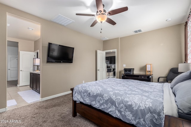 carpeted bedroom with ceiling fan and connected bathroom