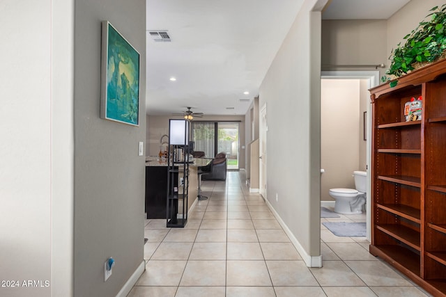 hall with light tile patterned floors