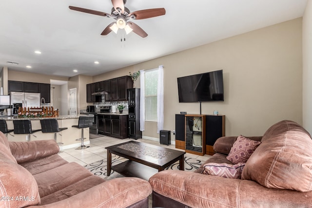 living room with ceiling fan and light tile patterned floors