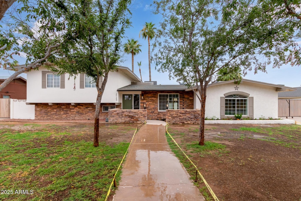 tri-level home with a front yard