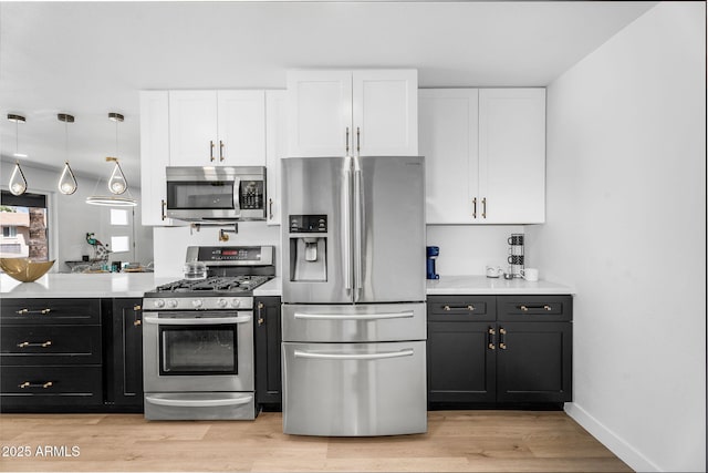 14635 N 37th Pl, Phoenix, AZ 85032 - kitchen with appliances with stainless steel finishes, white cabinetry, light countertops, and light wood-type flooring