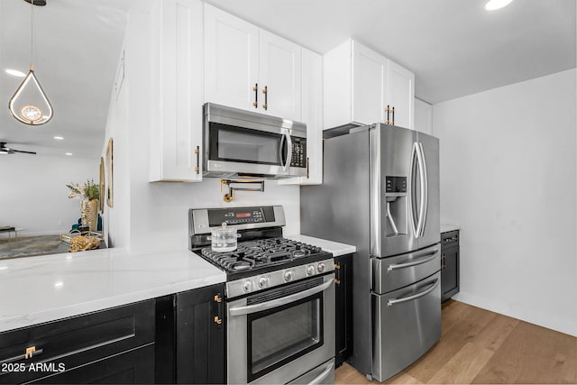 14635 N 37th Pl, Phoenix, AZ 85032 - kitchen with stainless steel appliances, white cabinets, dark cabinets, light wood finished floors, and recessed lighting