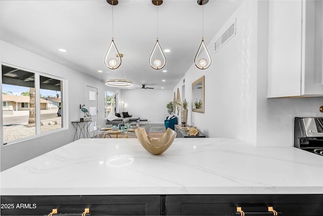 14635 N 37th Pl, Phoenix, AZ 85032 - kitchen featuring open floor plan, light stone countertops, recessed lighting, dark cabinetry, and pendant lighting