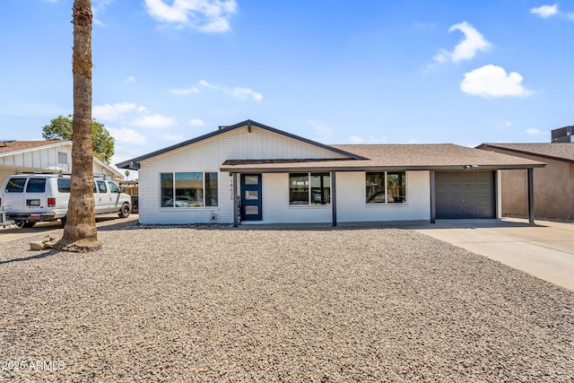 14635 N 37th Pl, Phoenix, AZ 85032 - view of front facade featuring a garage, concrete driveway, brick siding, and a shingled roof