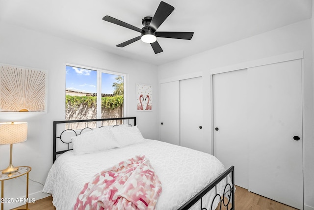 14635 N 37th Pl, Phoenix, AZ 85032 - bedroom featuring two closets, light wood finished floors, and ceiling fan