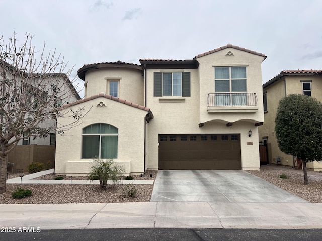 mediterranean / spanish-style home featuring a tile roof, concrete driveway, a garage, and stucco siding