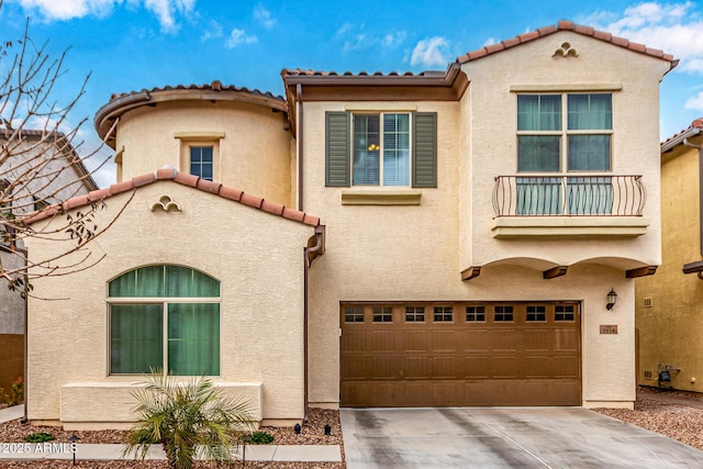 mediterranean / spanish-style house featuring concrete driveway, an attached garage, and stucco siding