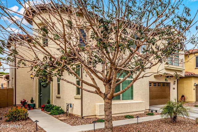 view of front of home featuring stucco siding, concrete driveway, and a garage