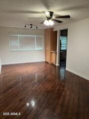 unfurnished living room with ceiling fan and dark hardwood / wood-style flooring