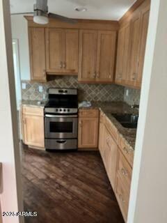 kitchen with dark hardwood / wood-style flooring, sink, decorative backsplash, and stainless steel electric range oven