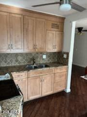 kitchen with dark hardwood / wood-style flooring, sink, backsplash, and ceiling fan