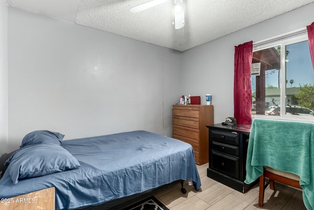 8623 W Indianola Ave, Phoenix, AZ 85037 - bedroom featuring a ceiling fan, a textured ceiling, and light wood-style flooring
