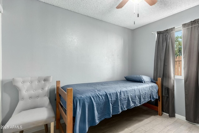 8623 W Indianola Ave, Phoenix, AZ 85037 - bedroom with baseboards, ceiling fan, a textured ceiling, and wood finished floors