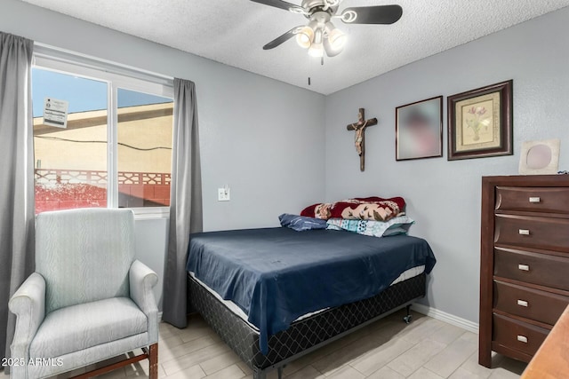 8623 W Indianola Ave, Phoenix, AZ 85037 - bedroom with a ceiling fan, a textured ceiling, multiple windows, and baseboards