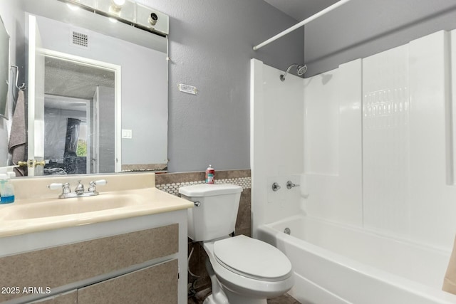 8623 W Indianola Ave, Phoenix, AZ 85037 - full bathroom featuring visible vents, vanity, a textured wall, bathing tub / shower combination, and toilet