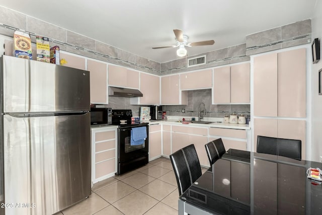 8623 W Indianola Ave, Phoenix, AZ 85037 - kitchen with visible vents, under cabinet range hood, a ceiling fan, light tile patterned floors, and black appliances