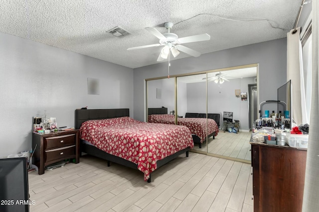 8623 W Indianola Ave, Phoenix, AZ 85037 - bedroom with ceiling fan, a closet, light wood-style flooring, and visible vents