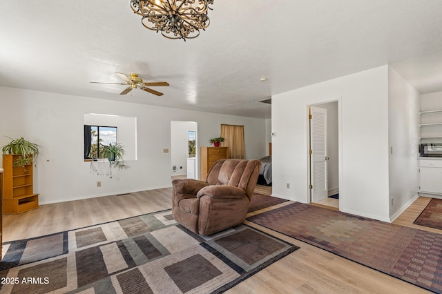 5766 N Juliane Dr, Williams, AZ 86046 - living room with wood finished floors, a ceiling fan, a chandelier, and baseboards