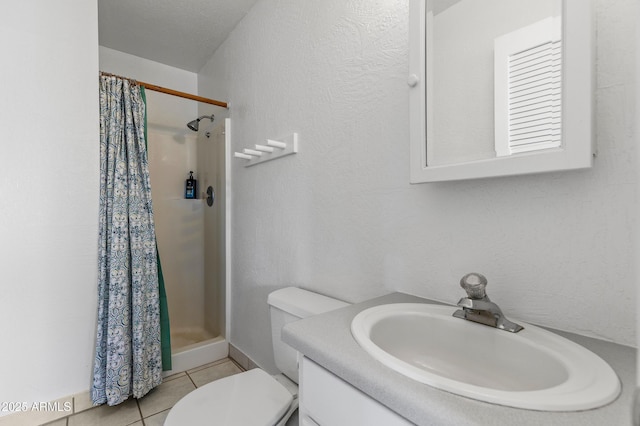 5766 N Juliane Dr, Williams, AZ 86046 - bathroom with a shower stall, toilet, vanity, tile patterned floors, and a textured wall