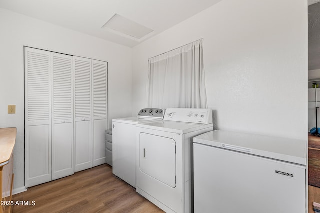 5766 N Juliane Dr, Williams, AZ 86046 - clothes washing area with washing machine and dryer, light wood finished floors, and attic access