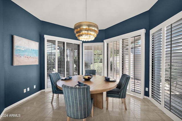 tiled dining space with a chandelier