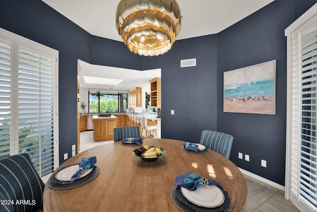 tiled dining area with a skylight