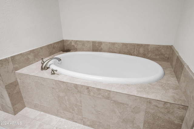 bathroom featuring tiled tub and tile patterned floors