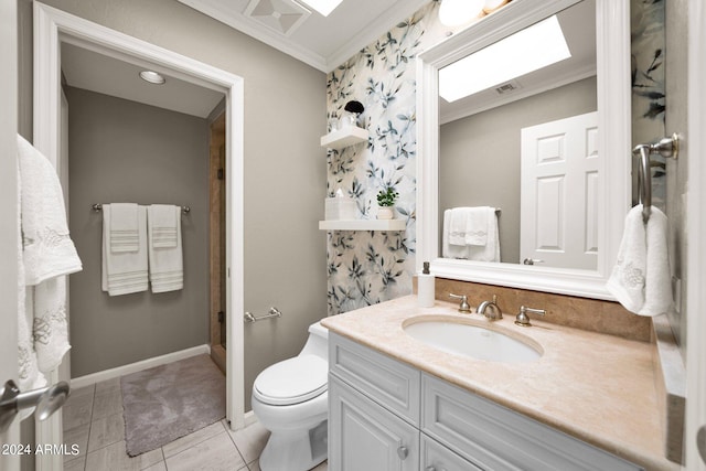 bathroom with tile patterned flooring, a skylight, ornamental molding, vanity, and toilet